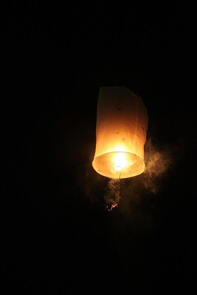 People are launching sky lanterns fire yeepeng is tradition in Floating lantern festival in northern of Thailand photo