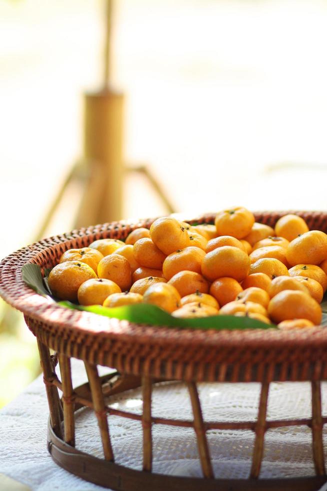 Fresh orange on banana leaves in wicker food tray. Thai buffet food tradition in event and wedding ceremony photo