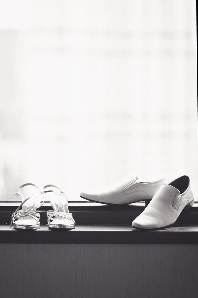 Bride and groom shoes on the glass window in wedding ceremony of hotel photo
