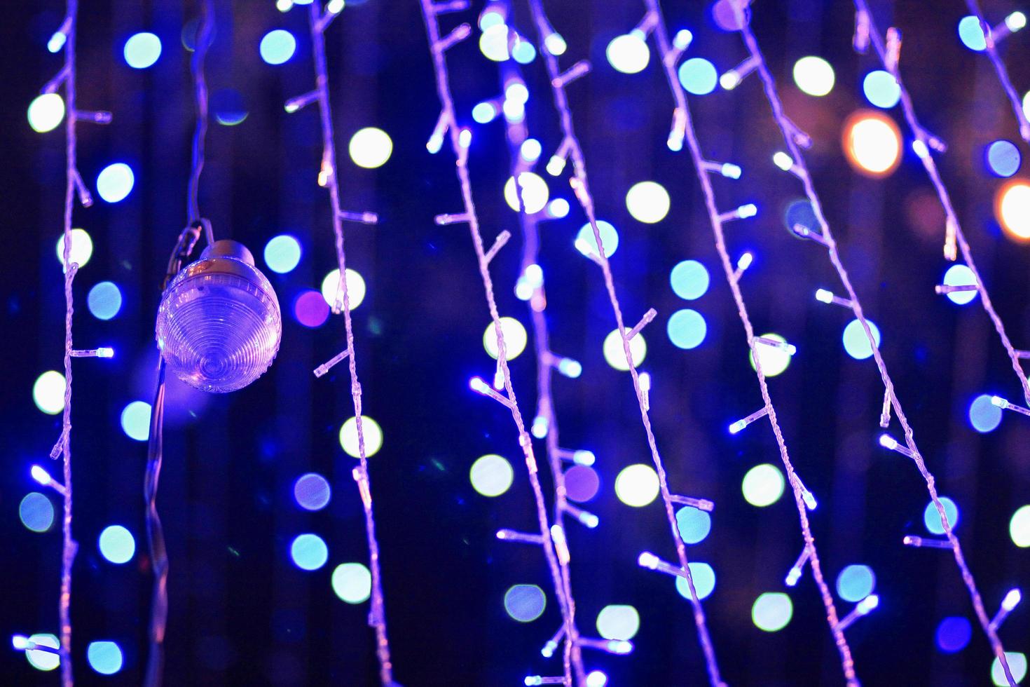 Glamour Ultra Violet sparkling and purple glitter bokeh. Multicolored Christmas and New Year glowing light abstract bokeh and blurred background.Christmas and holiday concept. photo