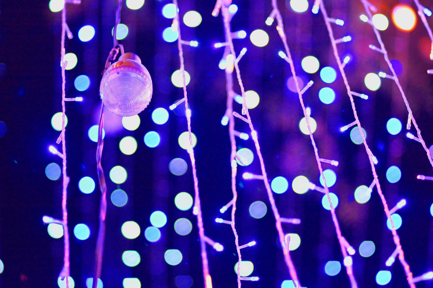 Glamour Ultra Violet sparkling and purple glitter bokeh. Multicolored Christmas and New Year glowing light abstract bokeh and blurred background.Christmas and holiday concept. photo