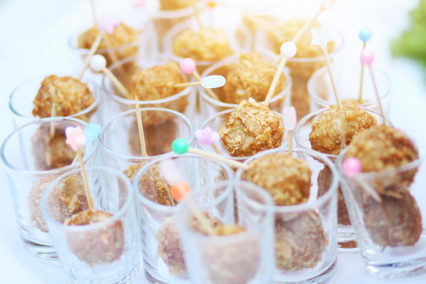 Thai Spring Roll and Fried meatballs in small glass cup decorated on buffet table photo