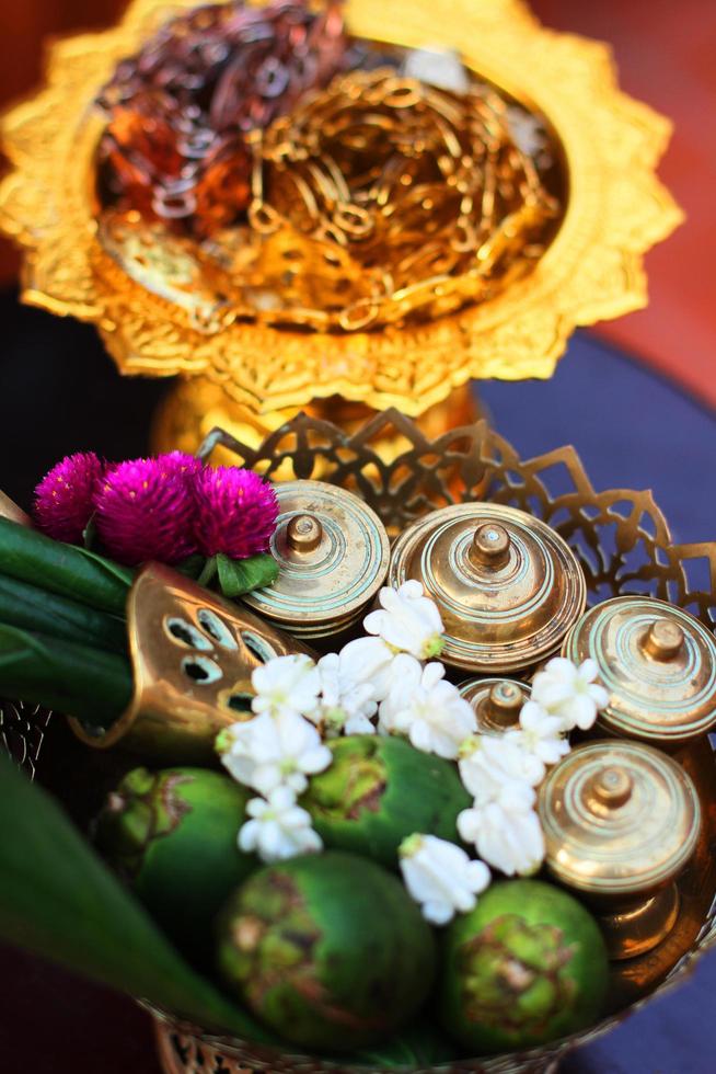 Silver and Gold Thai accessory, Green betel nuts and Marigold flowers on golden tray for Wedding ceremony in Thailand traditional photo