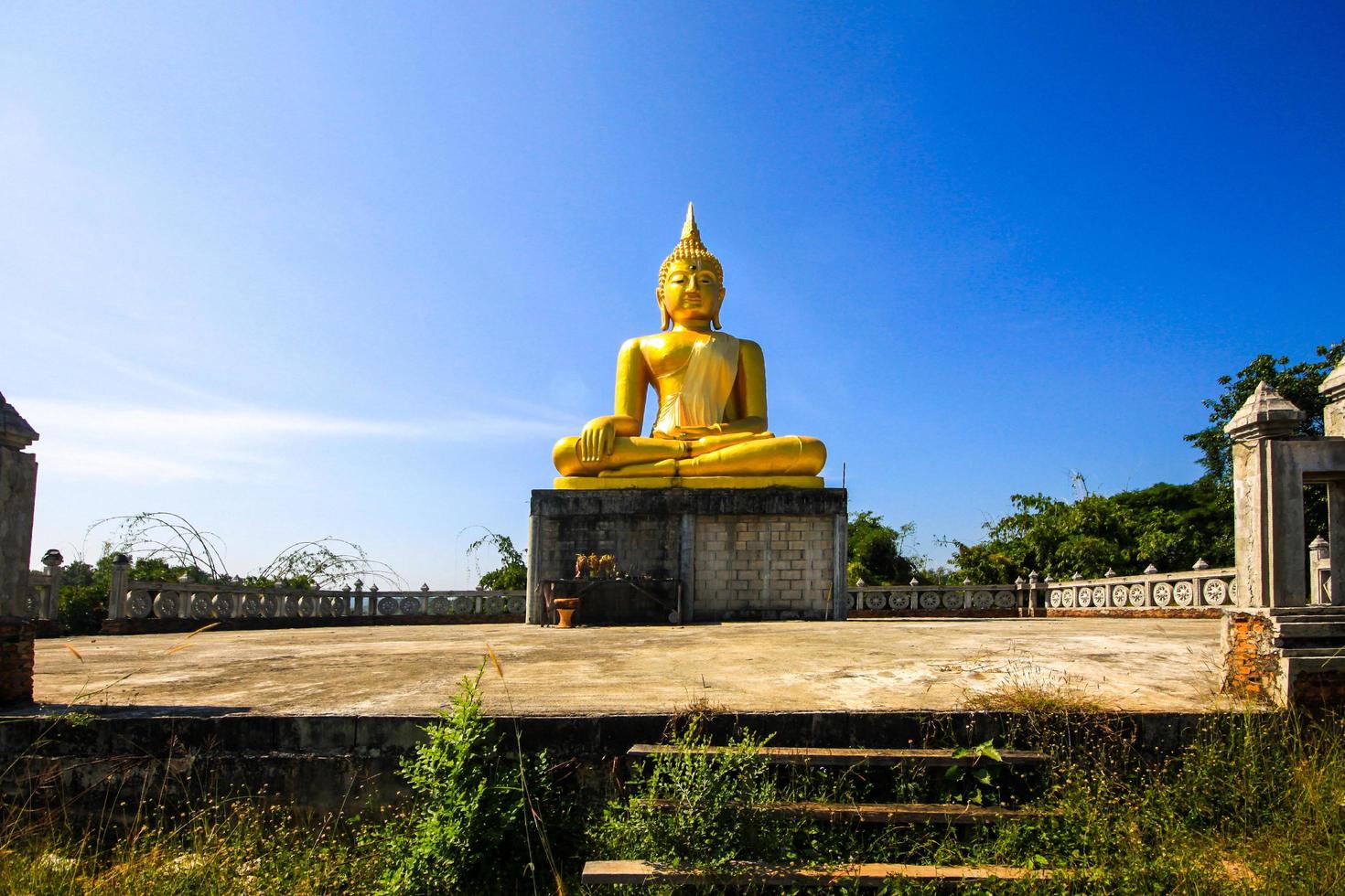 Golden Buddha statue and the old pagoda at ancient temple, Thailand photo