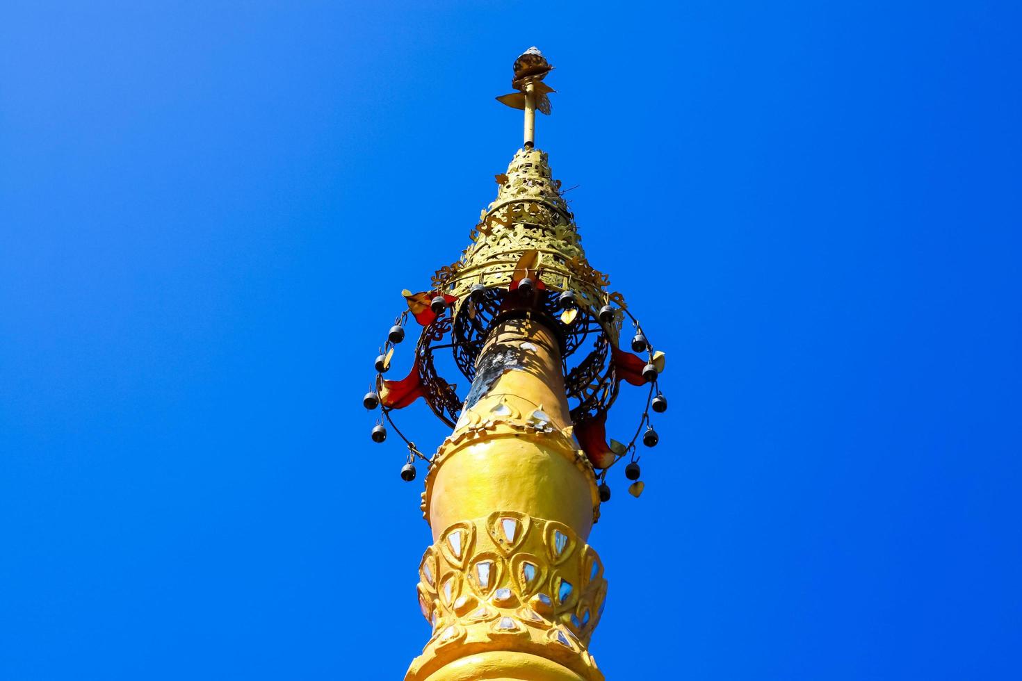 Golden pagoda detail is on architectural style at temple located in Kanchanaburi Province, Thailand. photo