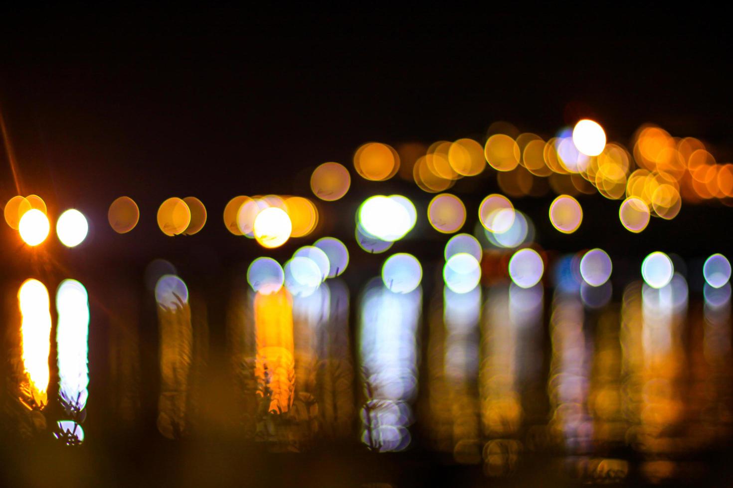 beautiful Night light with bokeh blurred on river and reflex in water colorful celebrate background photo