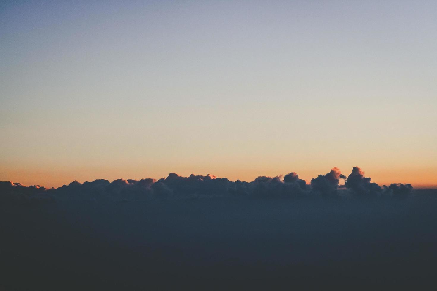 Sunset in sky and cloud, beautiful colorful twilight time with silhouette of mountain. photo
