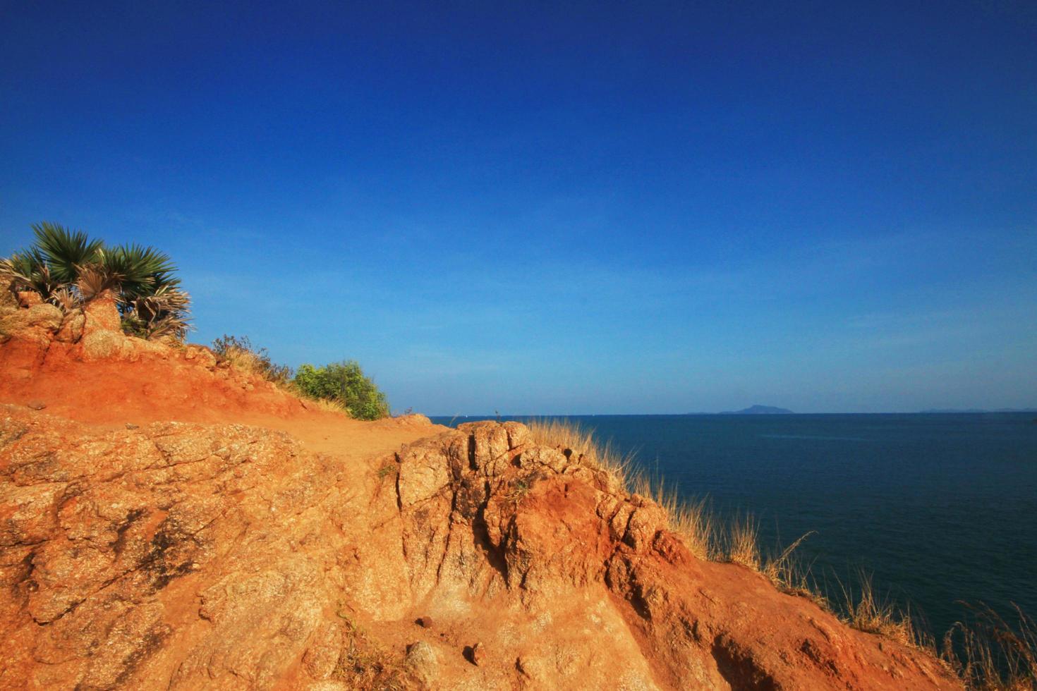 Beautiful seascape with sky twilight of sunset and sea horizon with Calm and blue sky.Dry grass field on mountain of Phrom Thep Cape is famous place in Phuket island, Thailand. photo