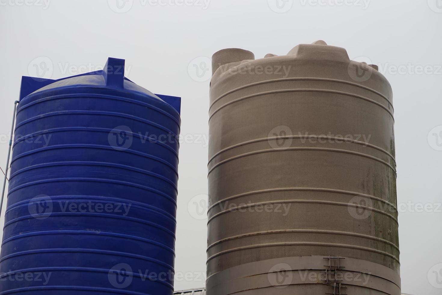 Big water tank outdoor for storage freshwater or rainwater to use in summer. Concept, prepare water to solve drought problems. Storage container for water using in accomodation or agriculture. photo