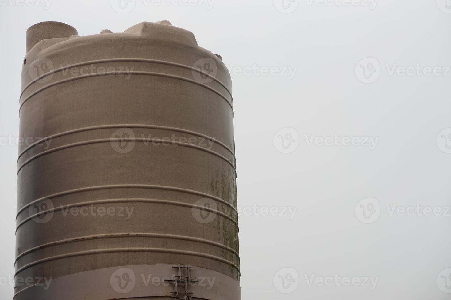 Big water tank outdoor for storage freshwater or rainwater to use in summer. Concept, prepare water to solve drought problems. Storage container for water using in accomodation or agriculture. photo