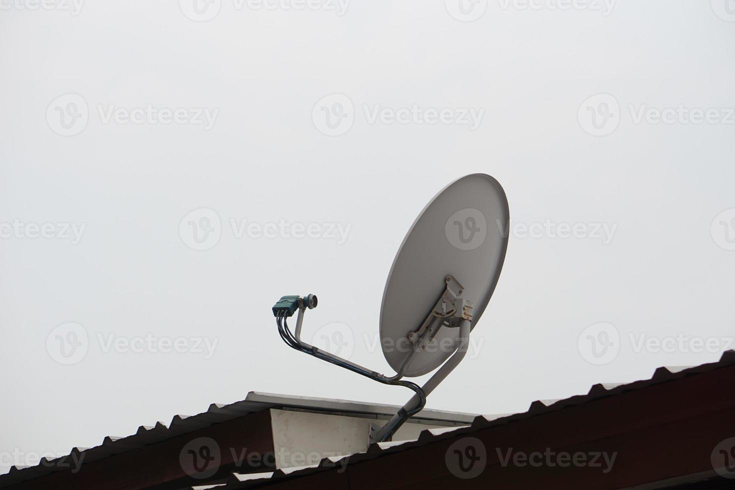Satellite receiver antenna installed on roof. Concept, technology for communication, global broadcast for digital reception through TV. photo