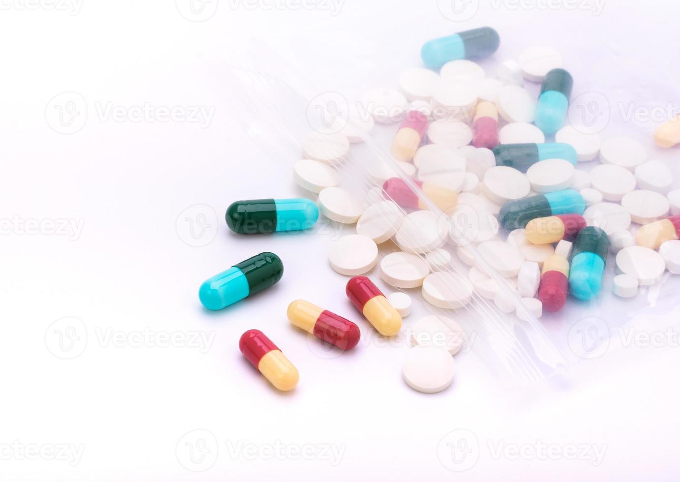 Colorful pills with capsules and pills in zip-lock plastic bags. isolated on white background photo