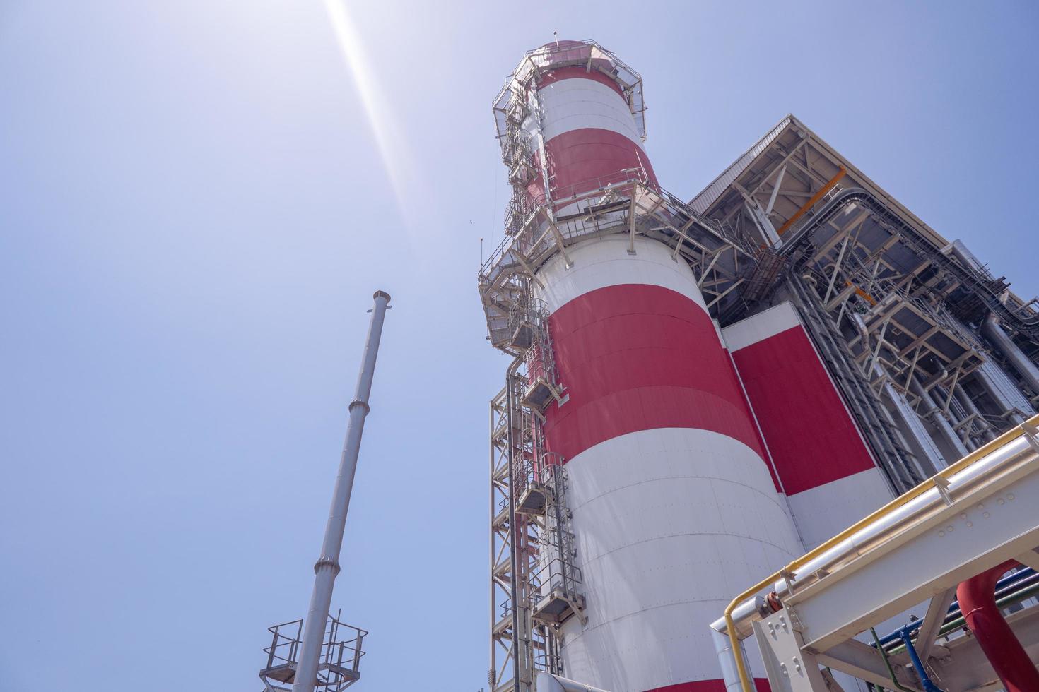 Landscape photo of chimney and stack of combine cycle power plant project. The photo is suitable to use for industry background photography, power plant poster and electricity content media.