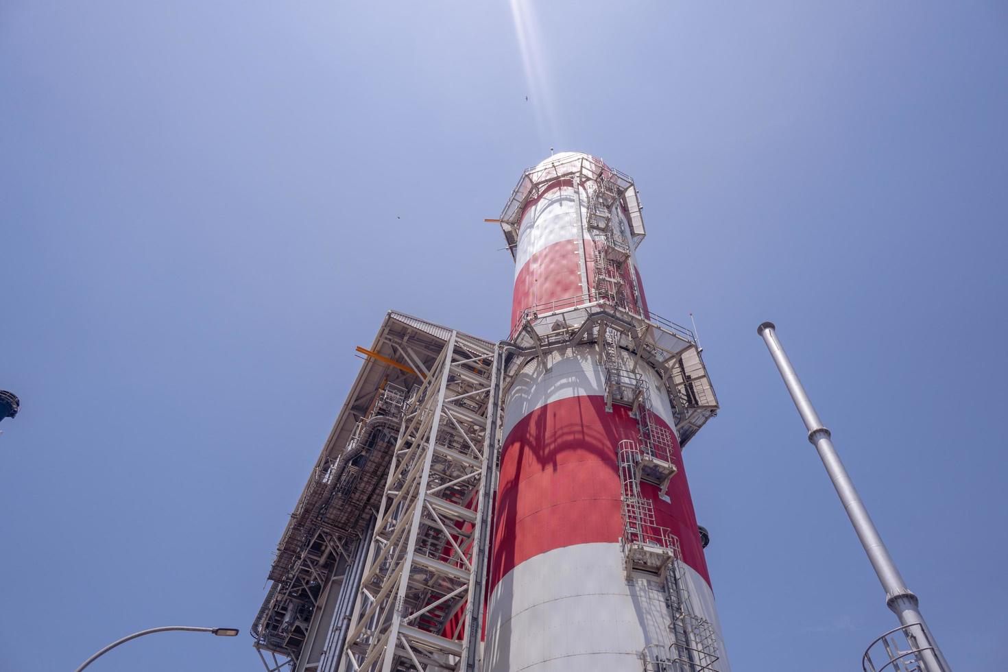 Landscape photo of chimney and stack of combine cycle power plant project. The photo is suitable to use for industry background photography, power plant poster and electricity content media.