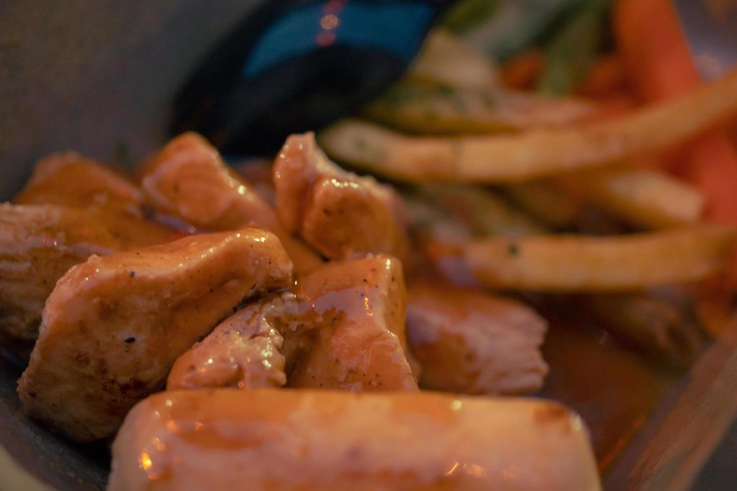 Fried chicken steak with fired fries bean and barbeque black paper sauce. The photo is suitable to use for food background, poster and food content media.