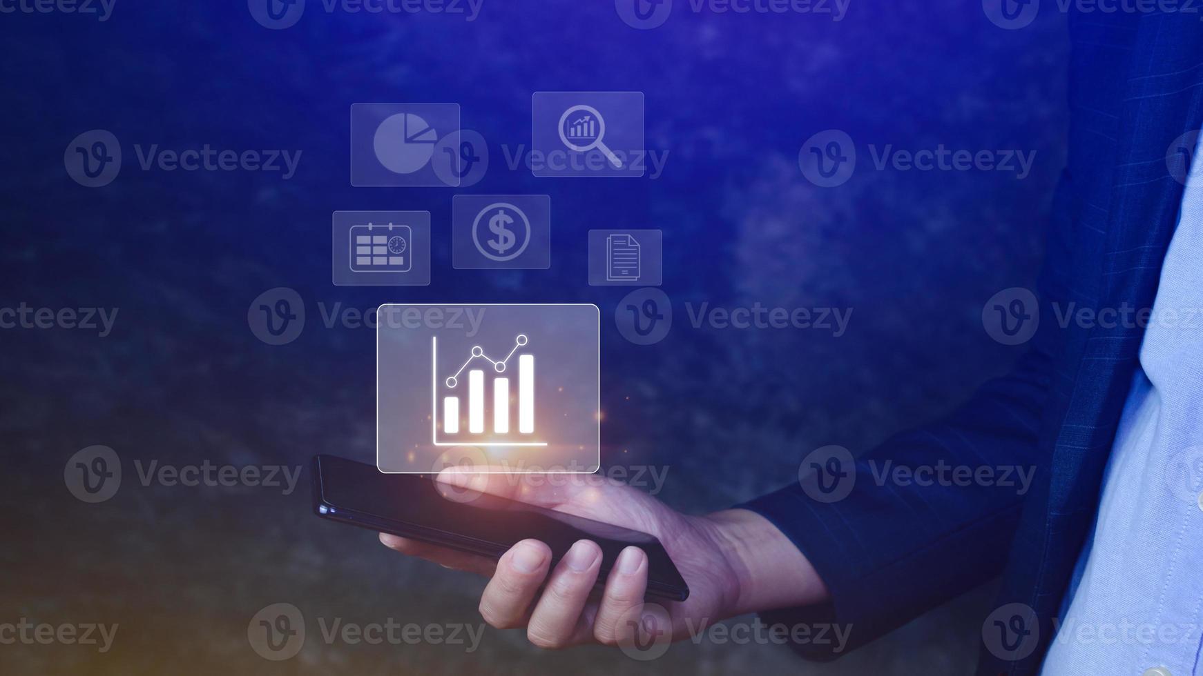 Data analytics and business intelligence BI concept with chart and graph icons on digital screen interface on smartphone and business people in the background. photo