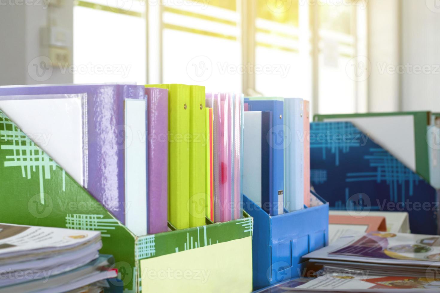 Colorful folders of personnel and office staff are kept and sorted in boxes in the office to evaluate their performance in order to raise their salary or increase their annual remuneration. photo