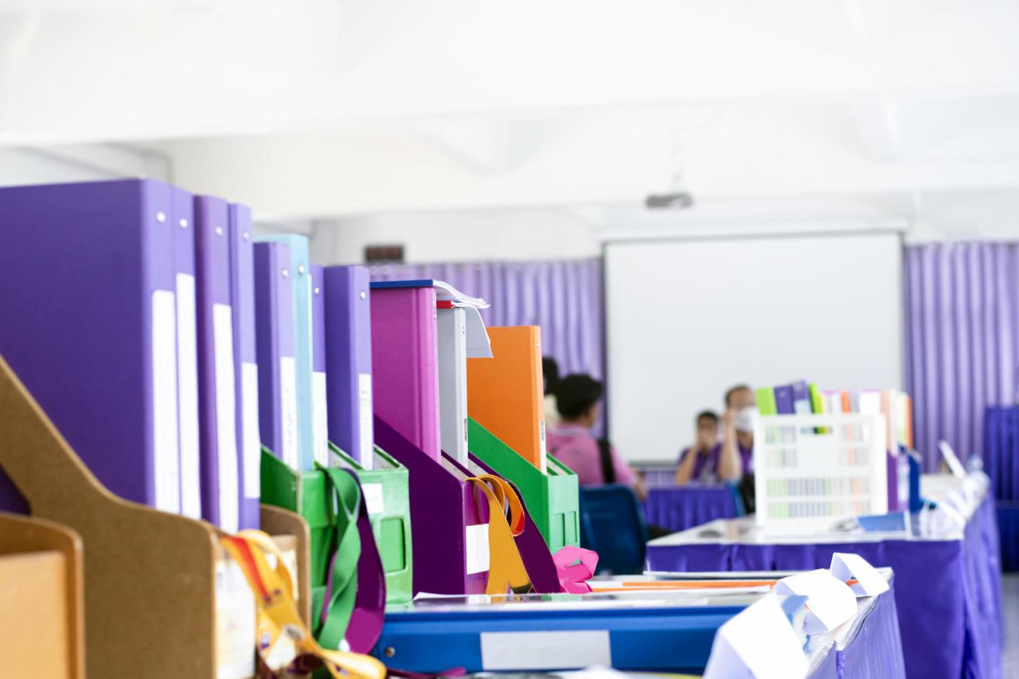 Colorful folders of personnel and office staff are kept and sorted in boxes in the office to evaluate their performance in order to raise their salary or increase their annual remuneration. photo