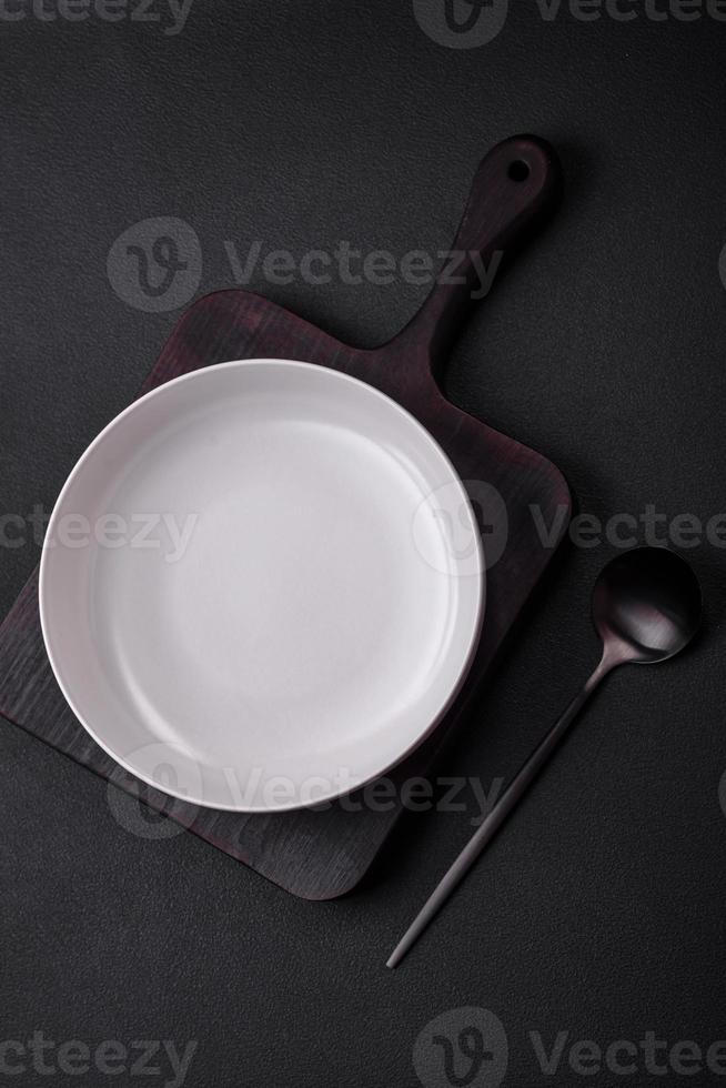 White empty soup bowl on a dark concrete background photo