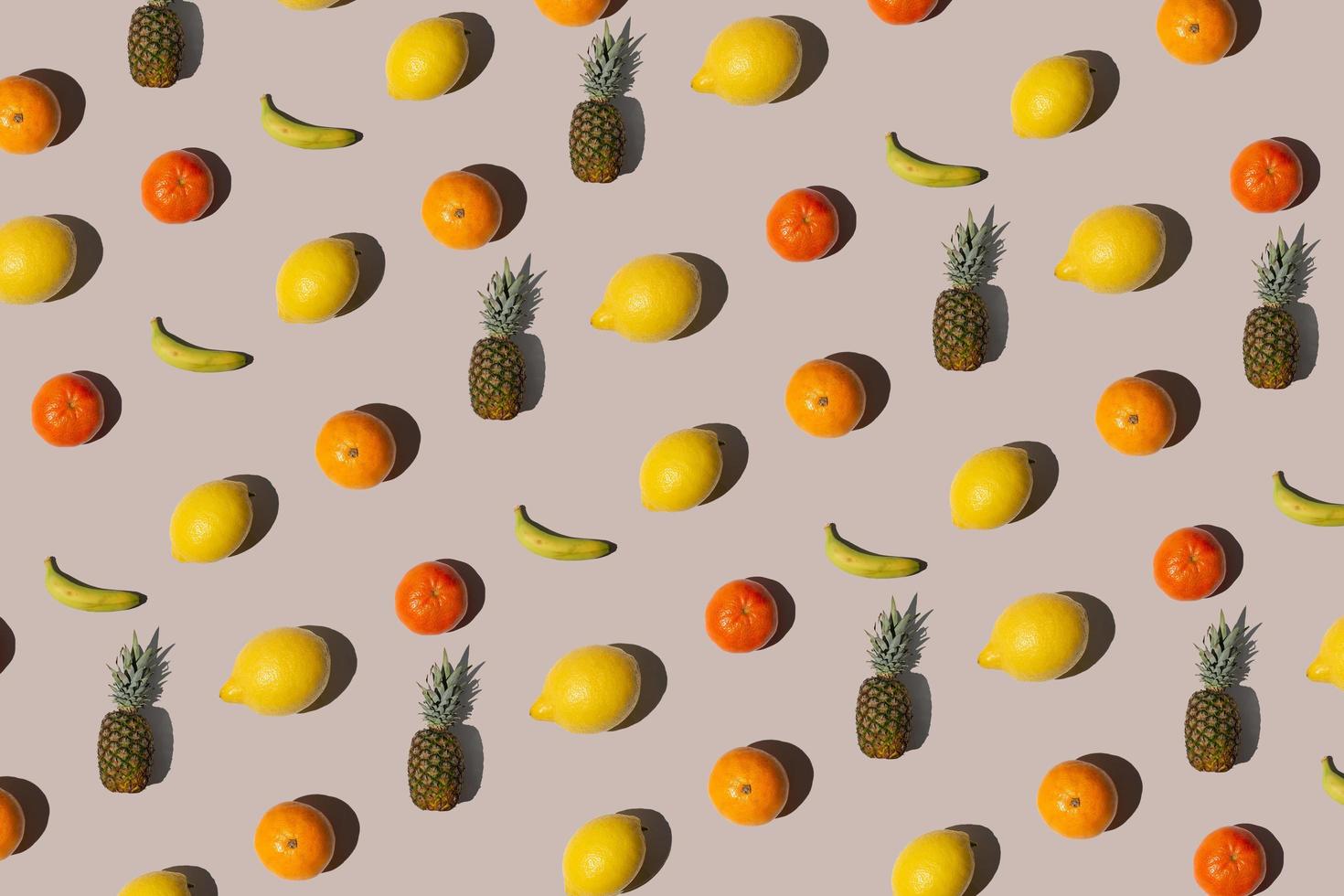 Creative isometric pattern made with tropical fruits on beige Background. Minimal summer fruit layout. photo