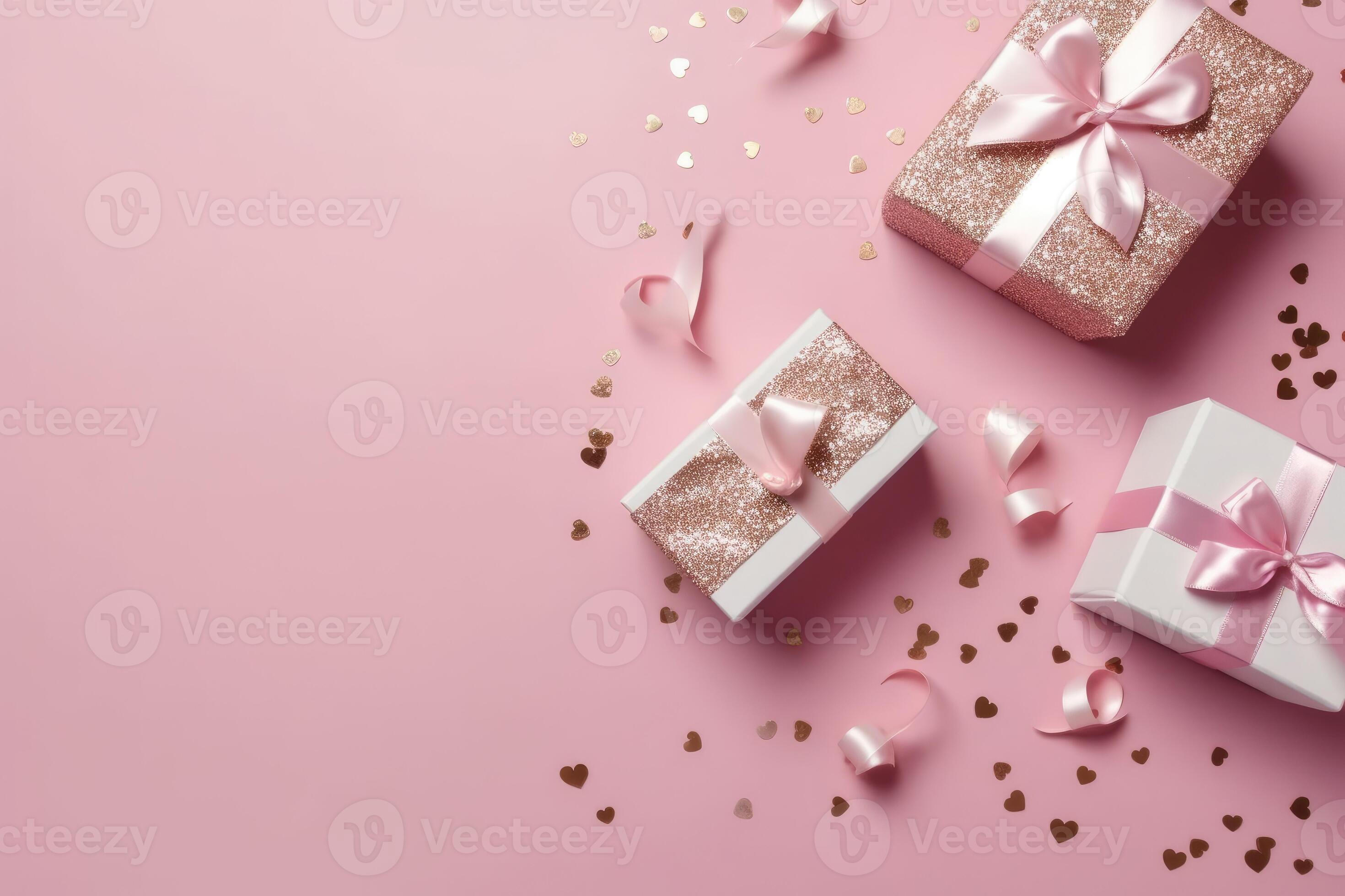 Top view photo of pink gift boxes with pink bow on isolated pastel pink