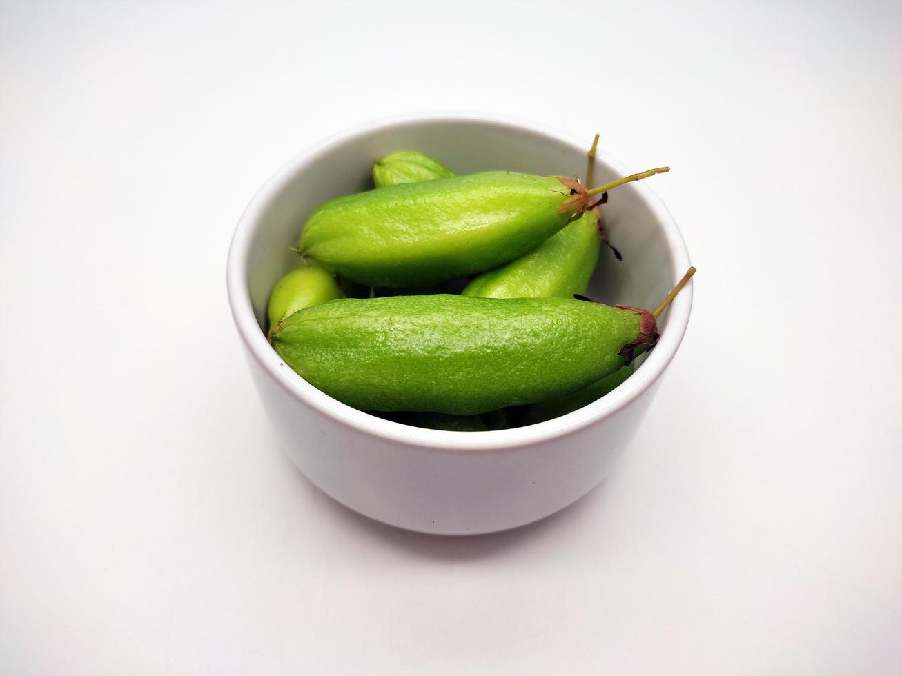 Bilimbi fruit or Bilimbing or Averrhoa bilimbi Linn in white bowl, isolated on white background photo