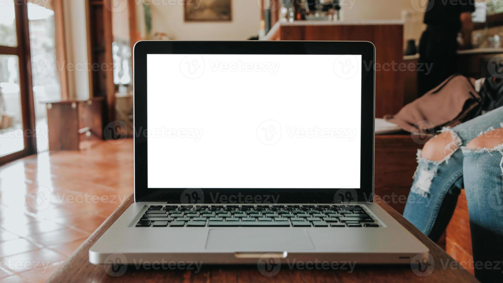 Blank screen laptop computer set up for work on white wooden desk, Mockup, Empty screen, Blank screen for product display. photo