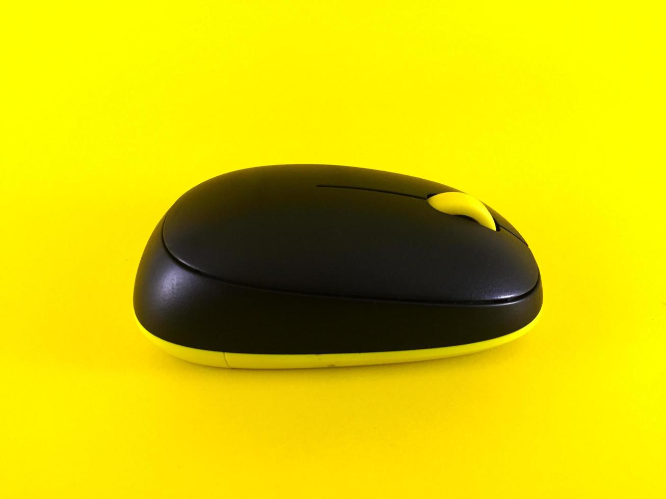 White wireless mouse on yellow background, minimal, flatlay photo