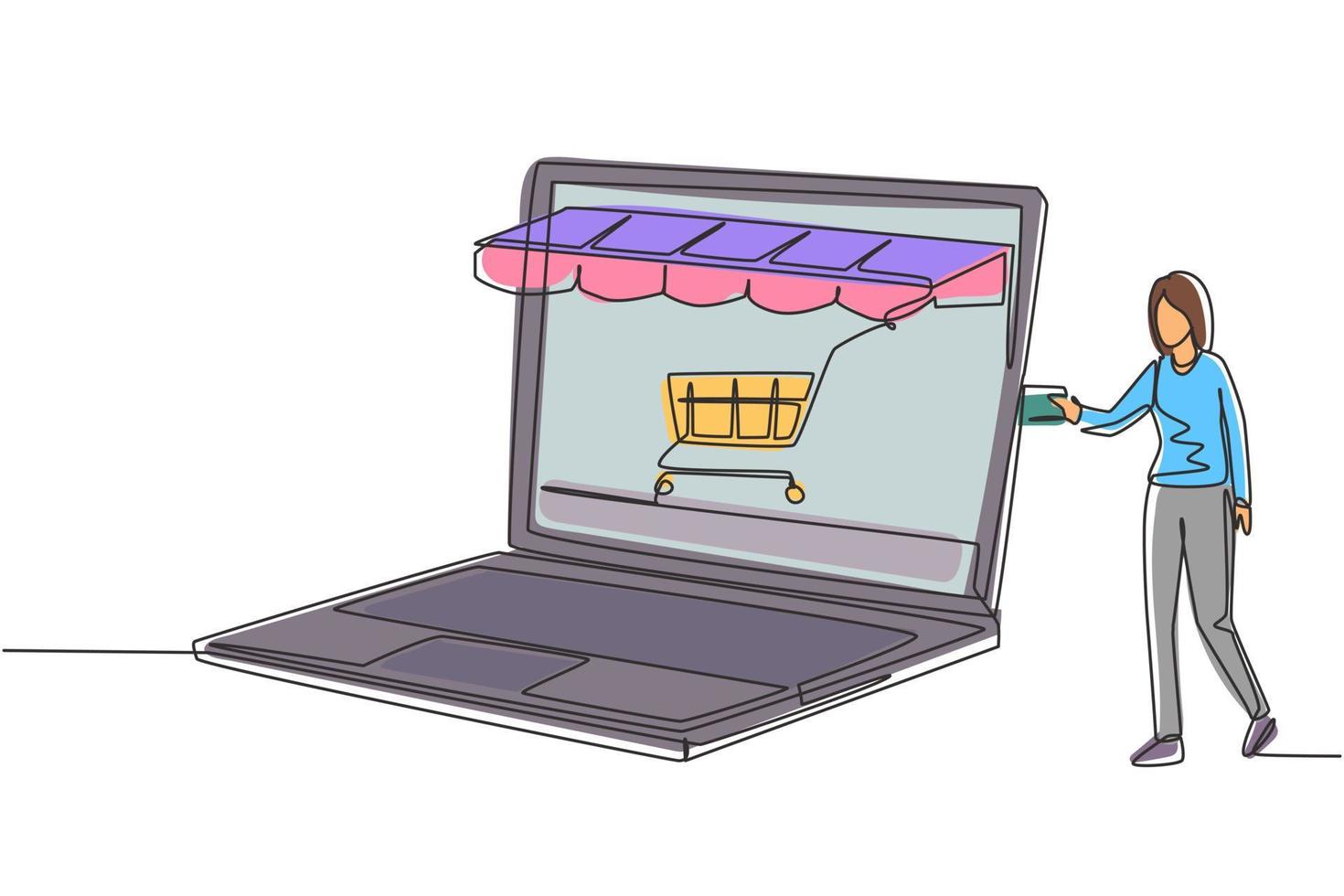 Continuous one line drawing young woman inserting credit card into large canopy laptop screen with shopping cart. E-shop, digital payment concept. Single line draw design vector graphic illustration