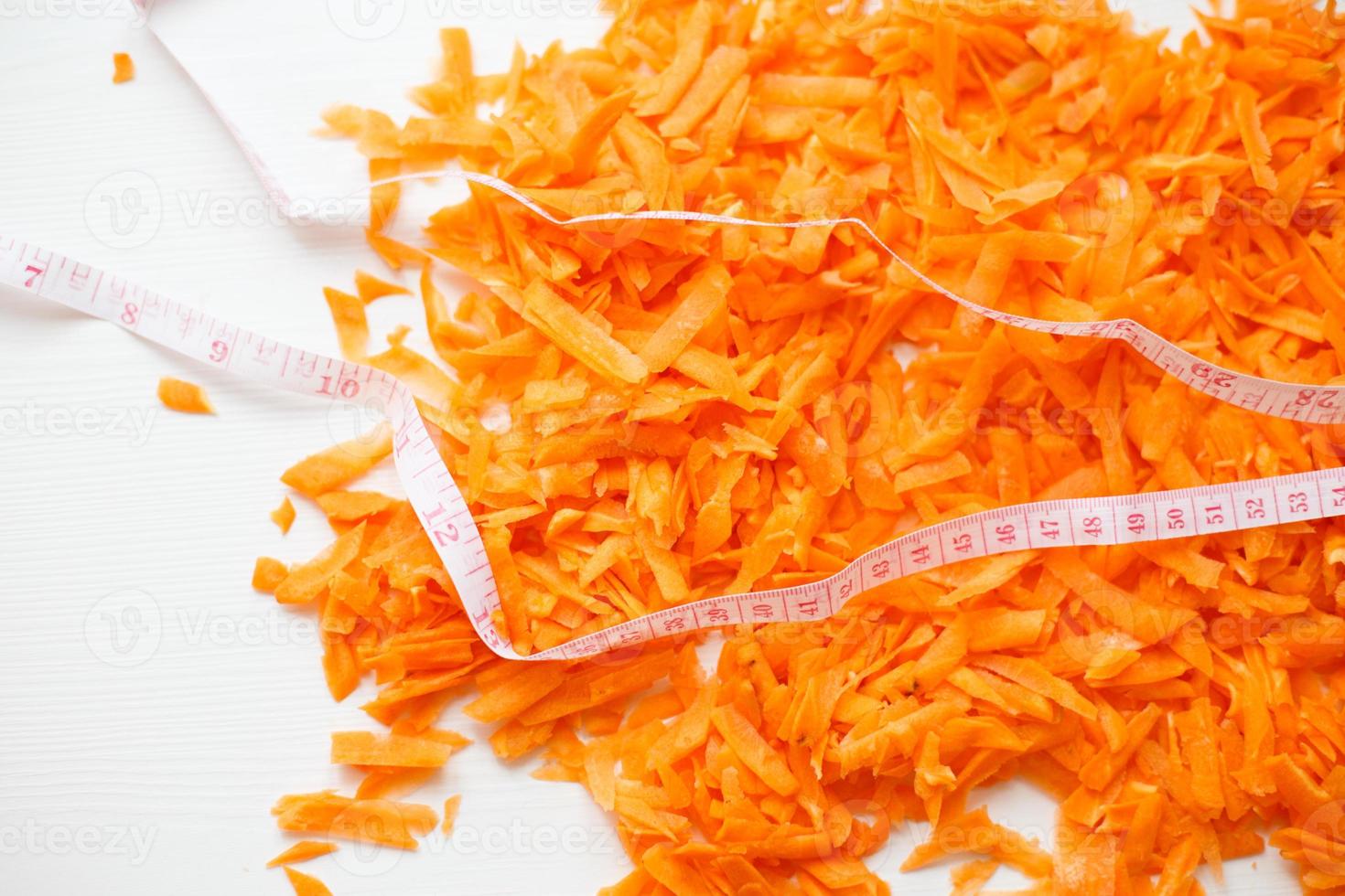 chopped carrots on a white background. raw carrots background photo