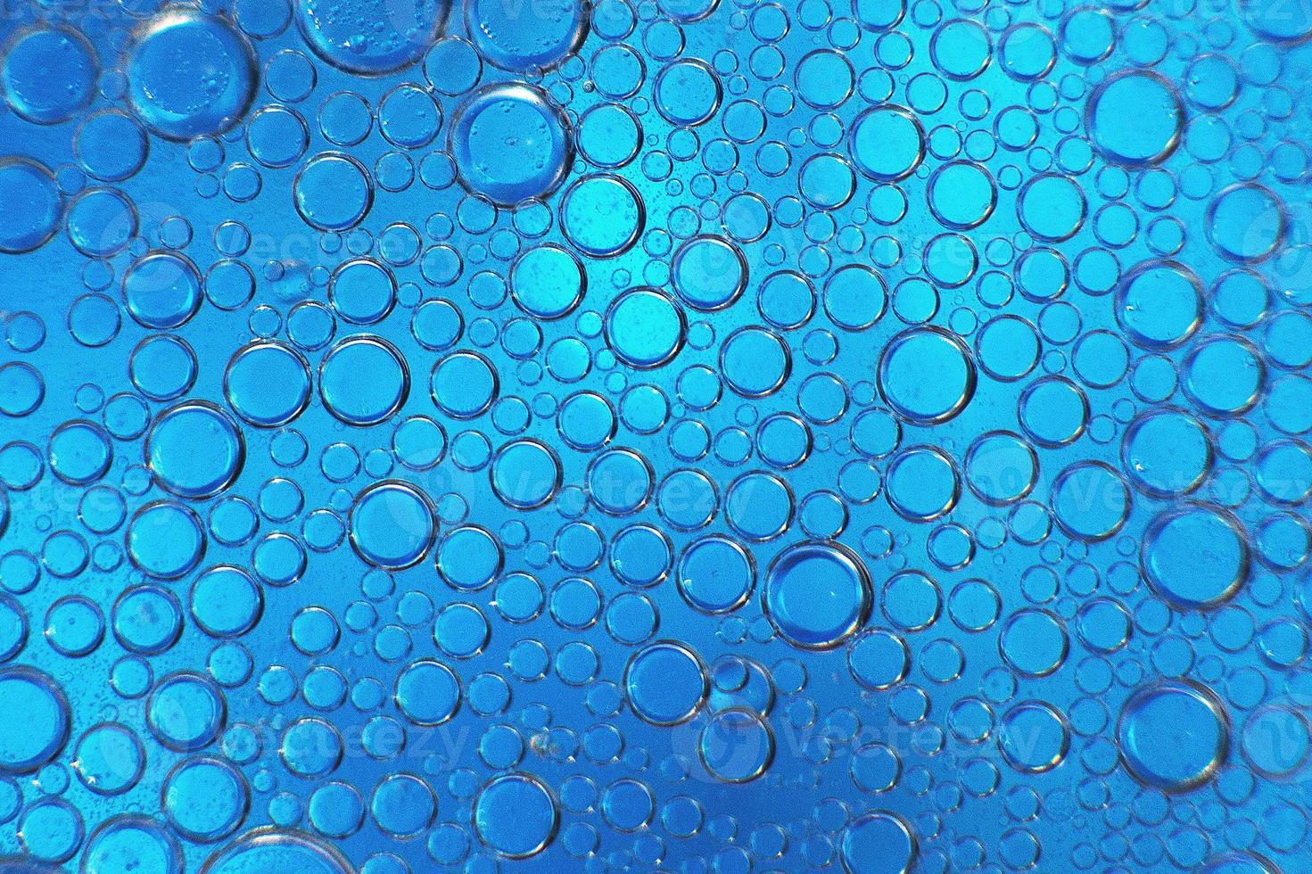 abstract light blue background with oil circles .  bubbles of water close up . oil bubbles in the water macro.  circle bubbles  background photo