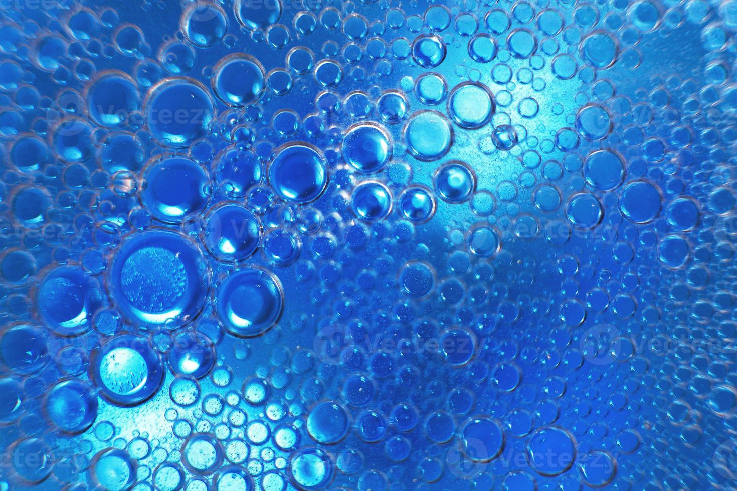 abstract light blue background with oil circles . bubbles of water close up . oil bubbles in the water macro. circle bubbles background photo