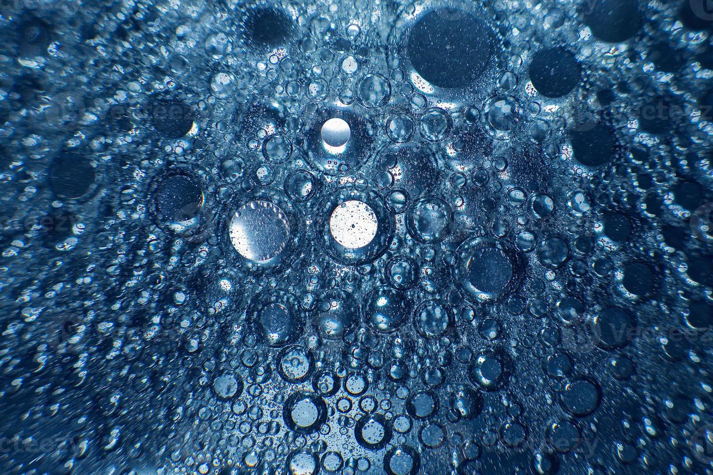 abstract light blue background with oil circles .  bubbles of water close up . oil bubbles in the water macro.  circle bubbles  background photo