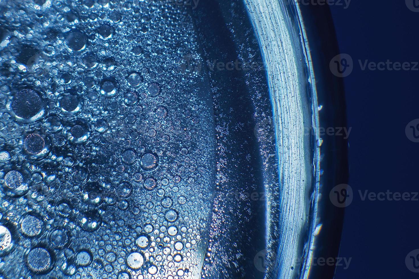 abstract light blue background with oil circles . bubbles of water close up . oil bubbles in the water macro. circle bubbles background photo