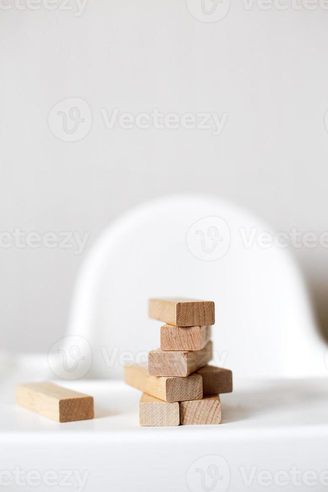 wooden pyramid on the highchair. stick game. photo