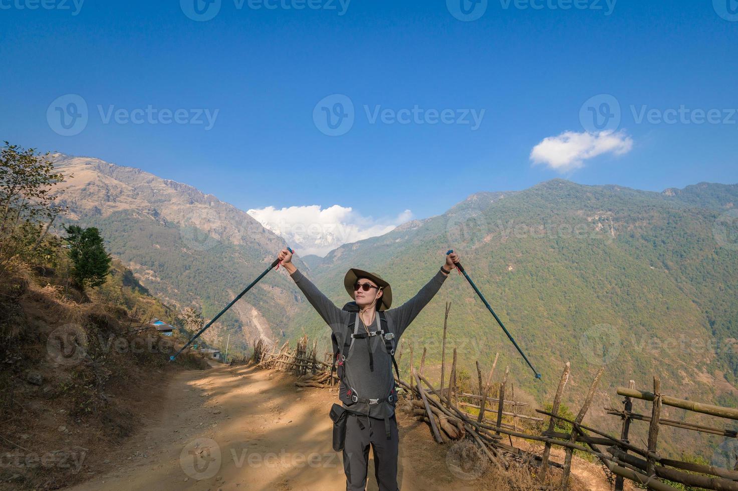A young traveller trekking on forest trail , Nepal photo
