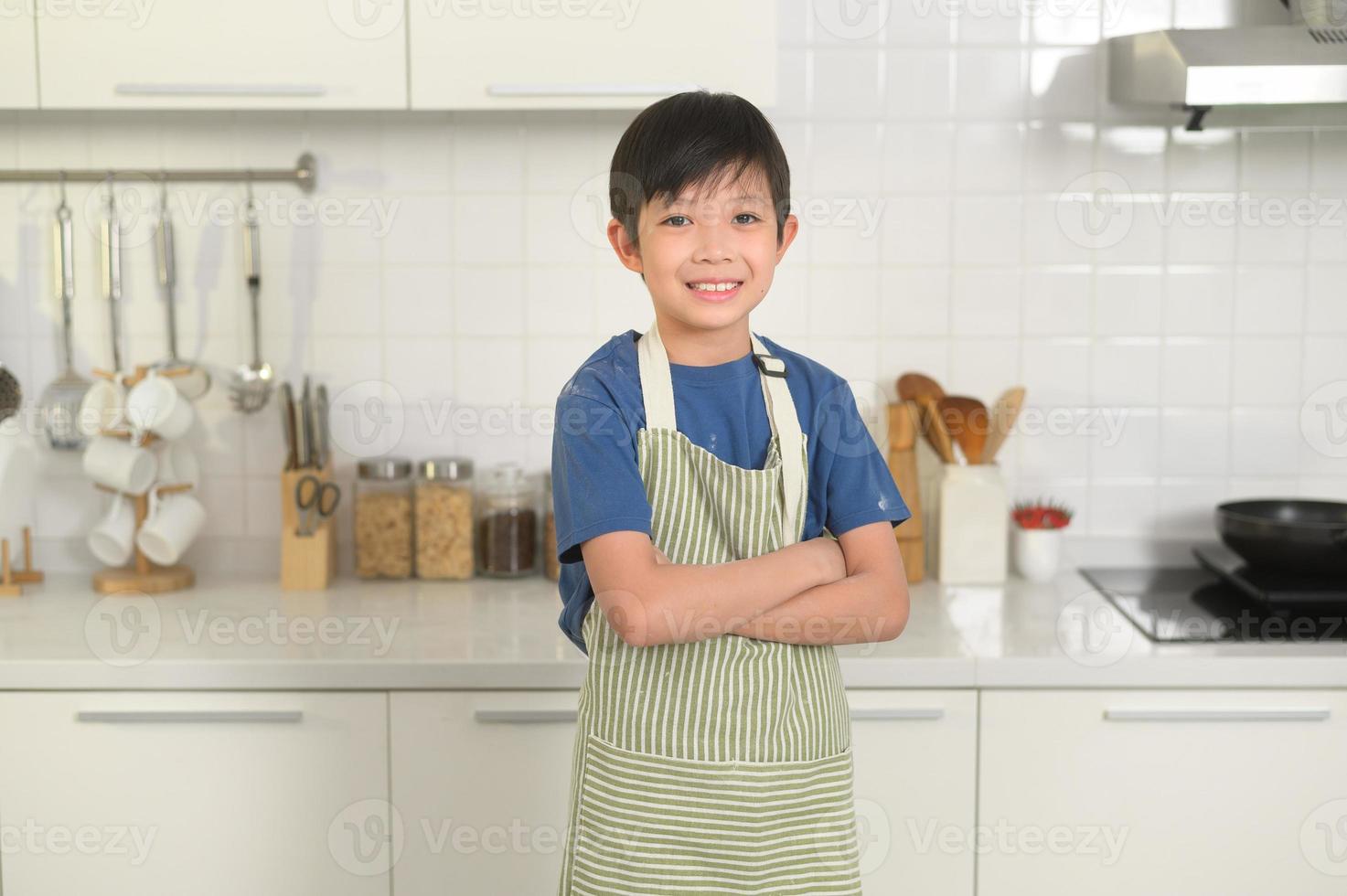 Portrait of smart boy smiling  in kitchen at home photo