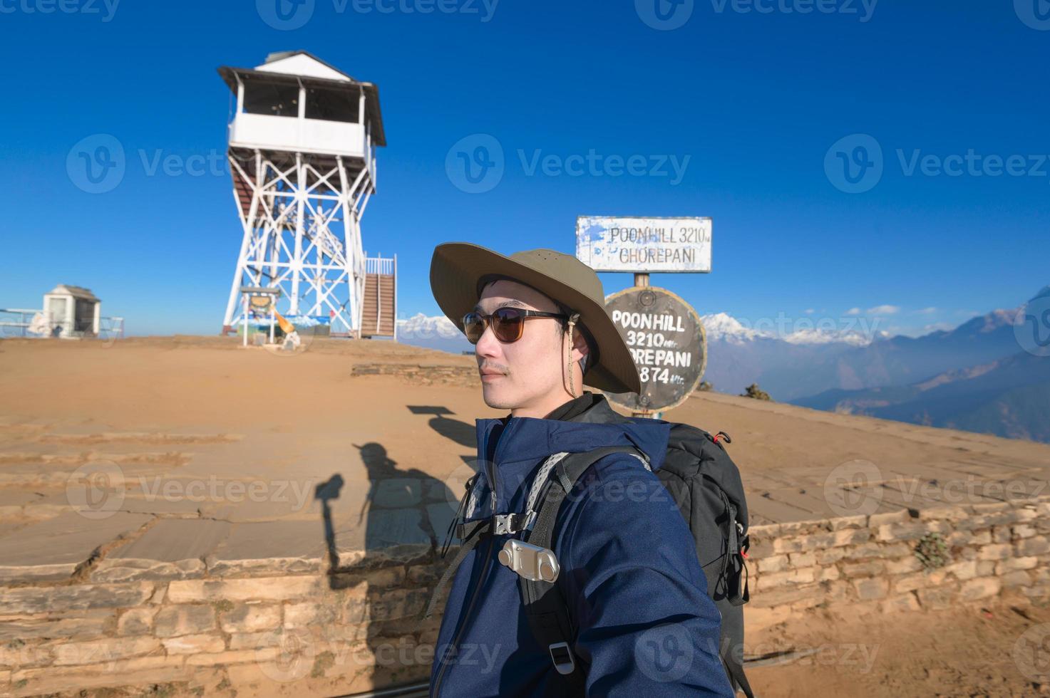 A young traveller trekking in Poon Hill view point in Ghorepani, Nepal photo