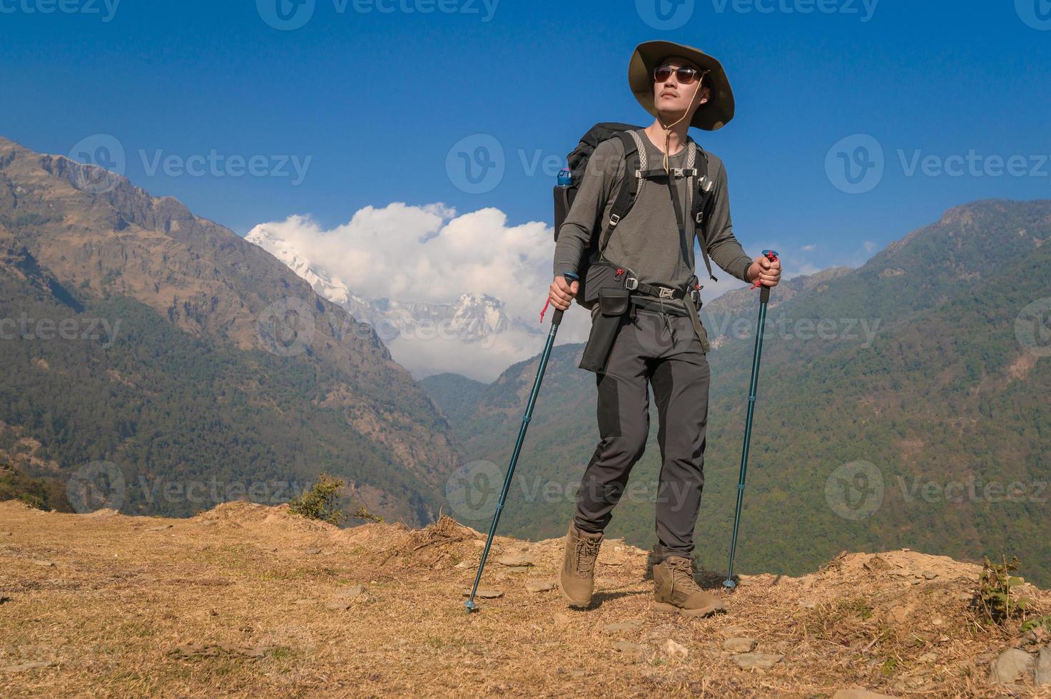 A young traveller trekking on forest trail , Nepal photo