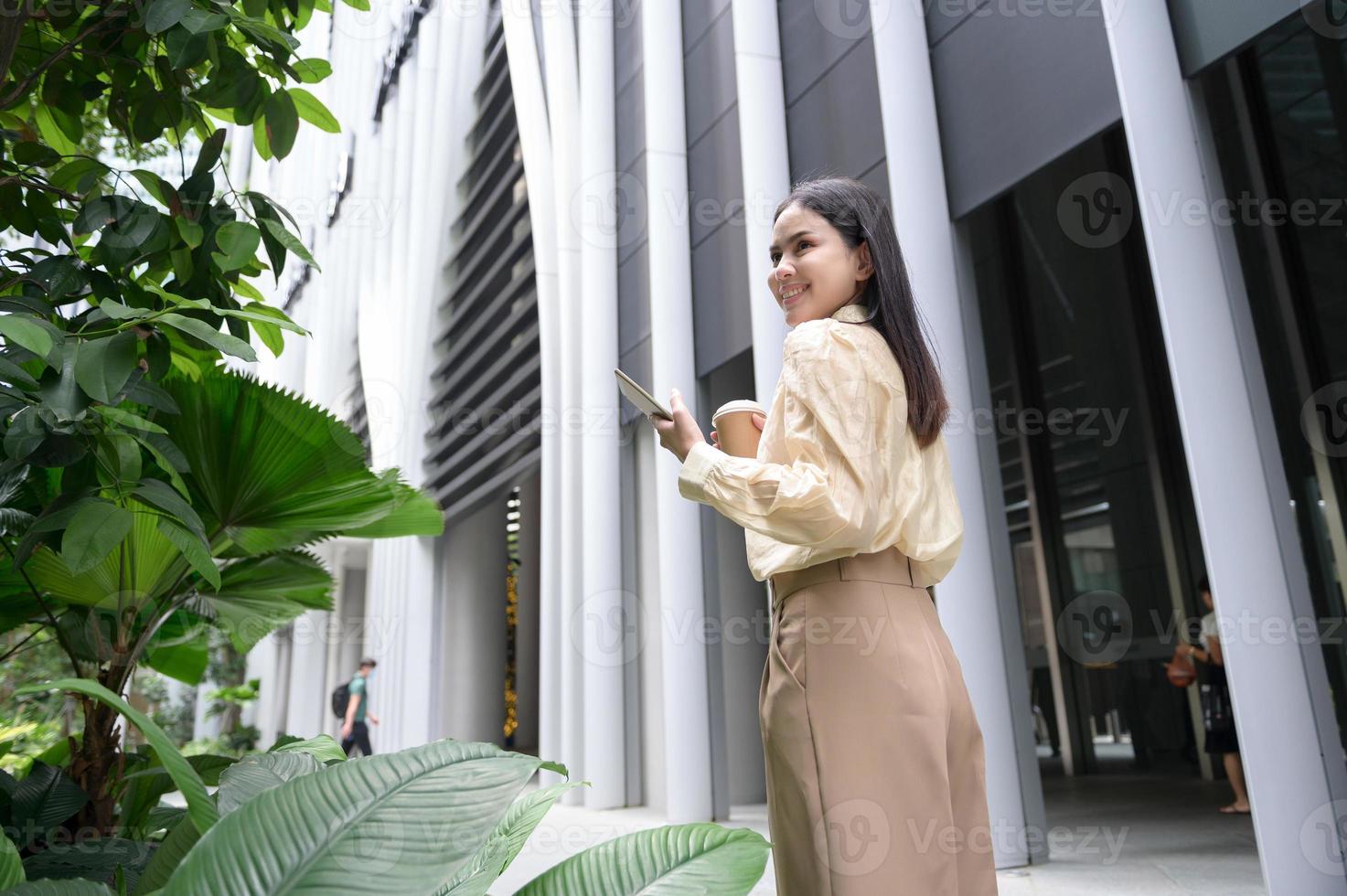 A young businesswoman is working in modern city downtown of Singapore photo