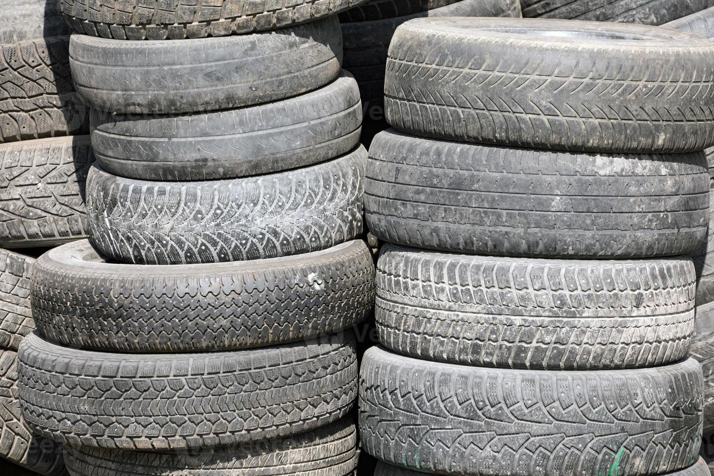 Old tires stacked in a pile, close-up photo. photo