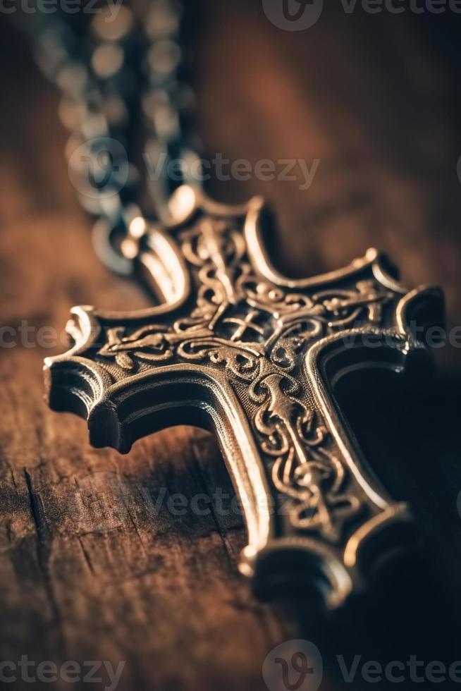 Close-up of a silver cross on a wooden table, shallow depth of field photo