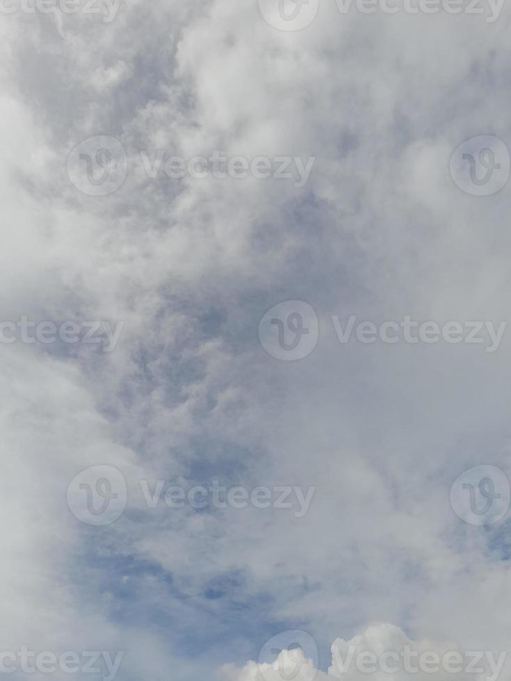 Beautiful white clouds on deep blue sky background. Large bright soft fluffy clouds are cover the entire blue sky. photo