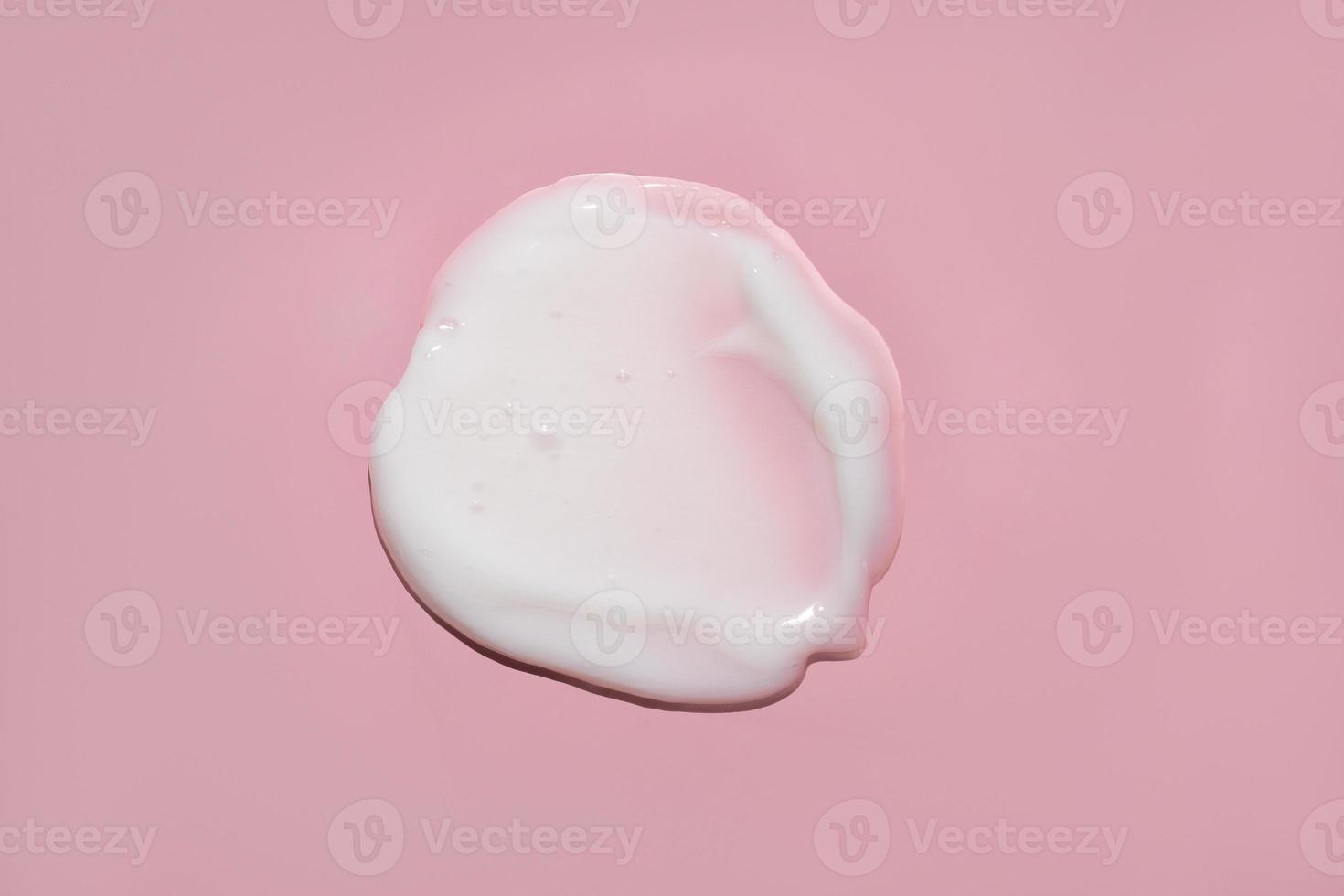 white cream with bubbles swatch on pink background photo