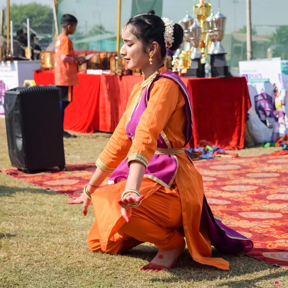 Delhi, India - March 11 2023 - Bharathanatyam Indian classical odissi dancers performing at stage. Beautiful Indian girl dancers in the posture of Indian dance. Indian classical dance Bharatanatyam photo