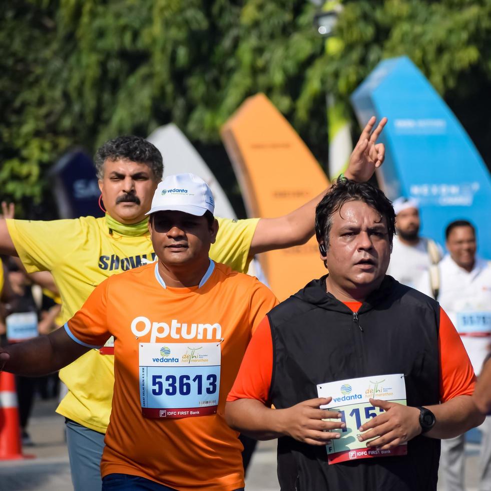 New Delhi, India - March 16 2023 - Vedanta Delhi Half Marathon race after covid in which marathon participants about to cross the finish line, Delhi Half Marathon 2022 photo