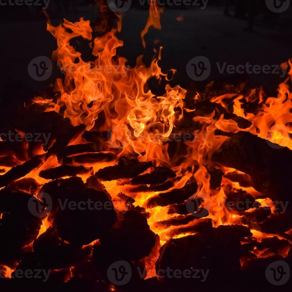 Fire flames on black background, Blaze fire flame texture background, Beautifully, the fire is burning, Fire flames with wood and cow dung bonfire photo