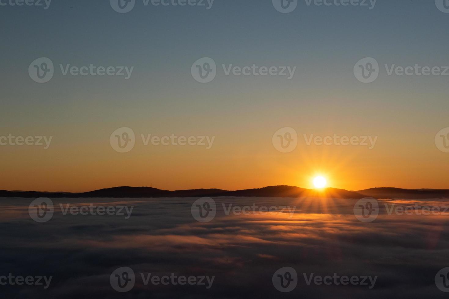 sunrise above the clouds photo