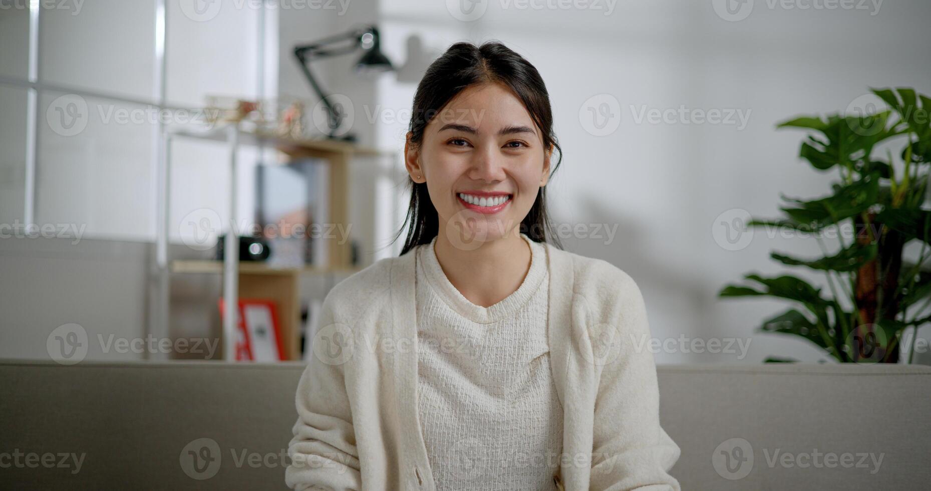 Portrait of A smiling Asian young woman looking at the camera with a big grin photo