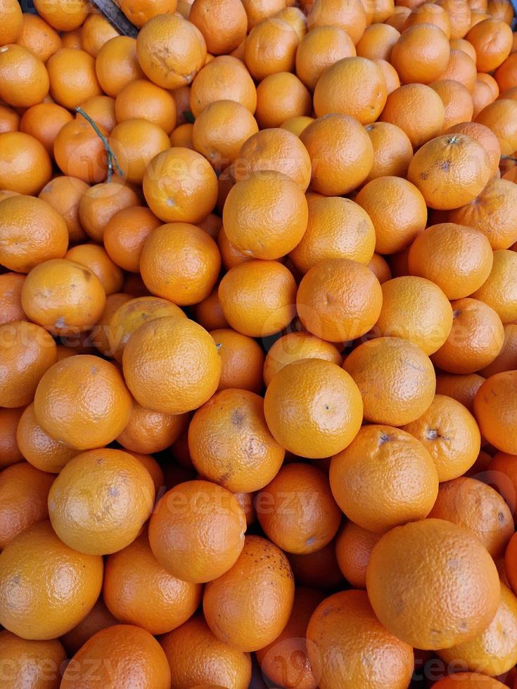 fruit background of ripe healthy oranges at the market stall photo